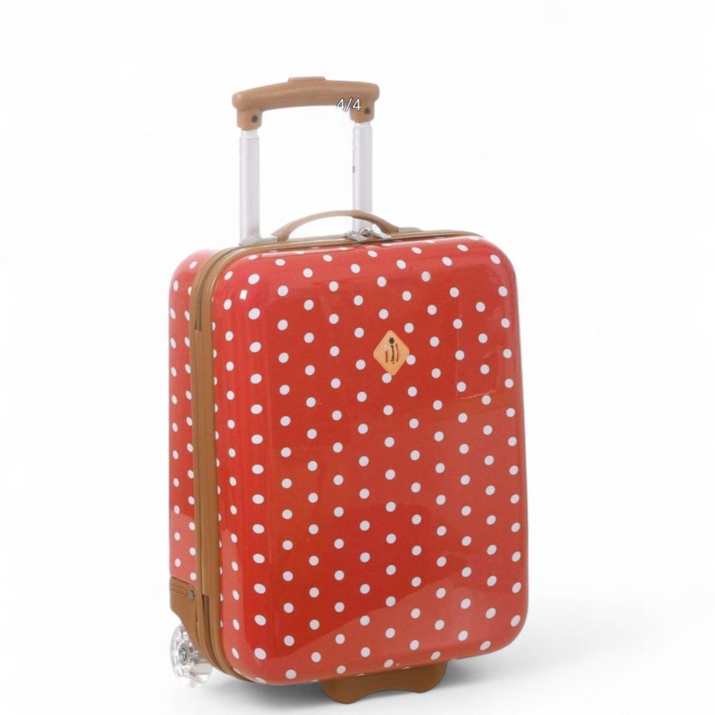 Valise à roulettes rouge à pois blancs, idéal pour enfants, en cuir souple, facile à manœuvrer.